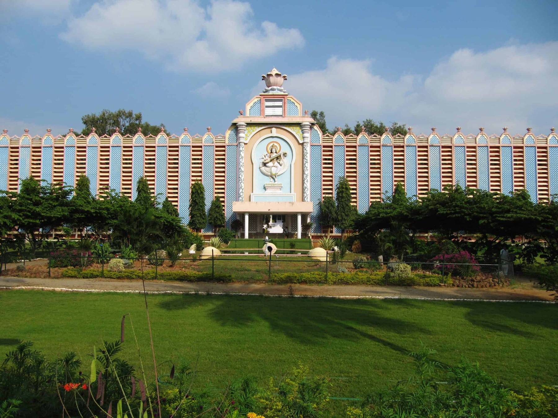 Sri Sathya Sai Institute of Higher Learning — the blue-and-white colonnade behind its gardens